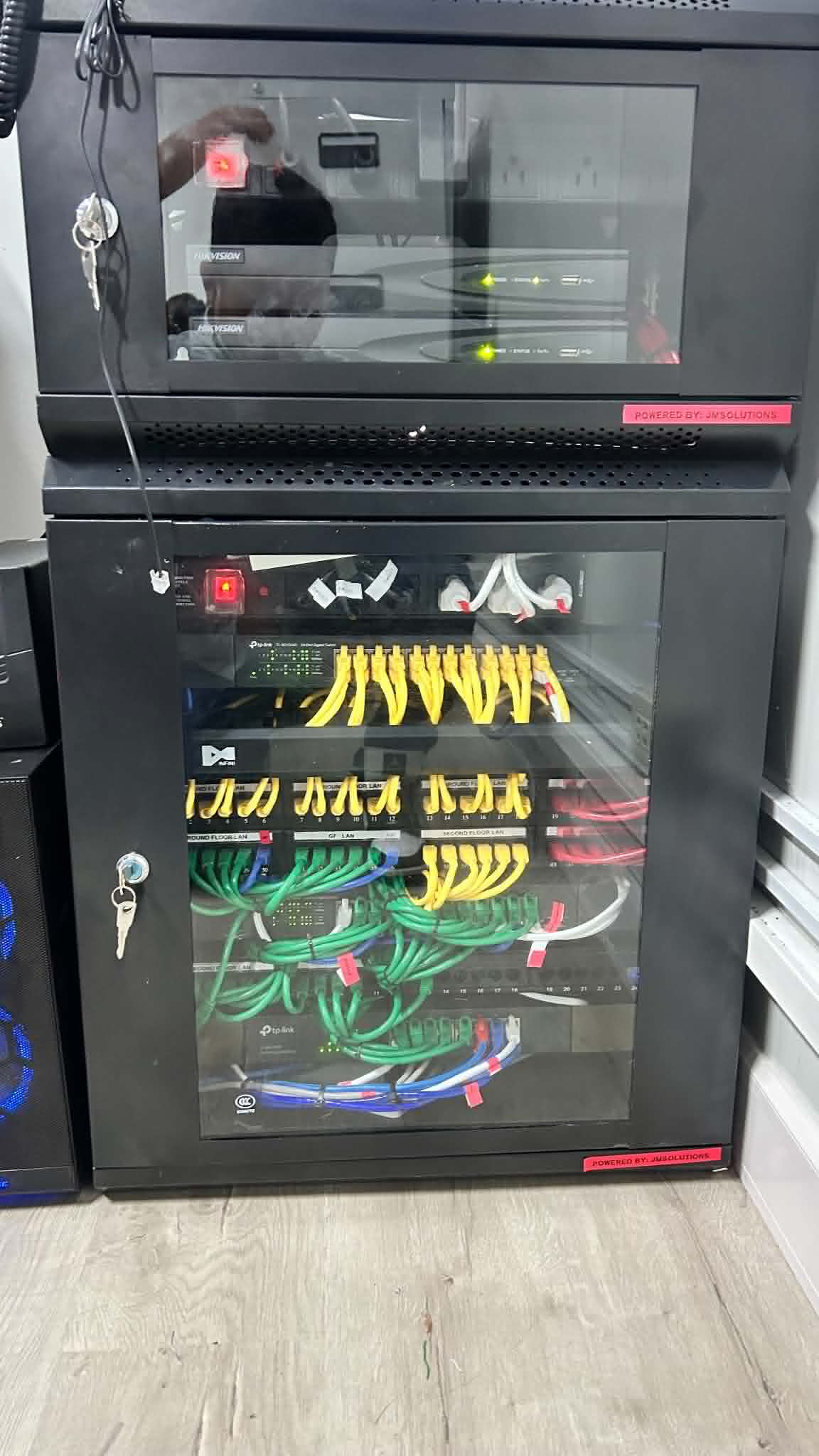 Compact rack system with monitor, switching, and structured cabling used for ongoing monitoring and technical support.