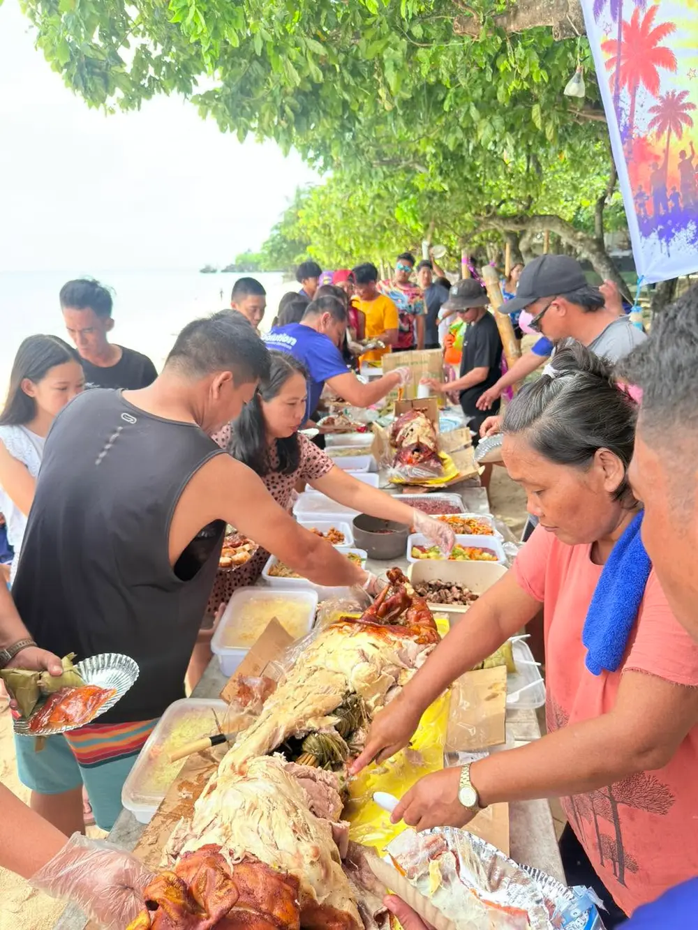 The team gathered around a long table for a boodle-fight style beach feast.