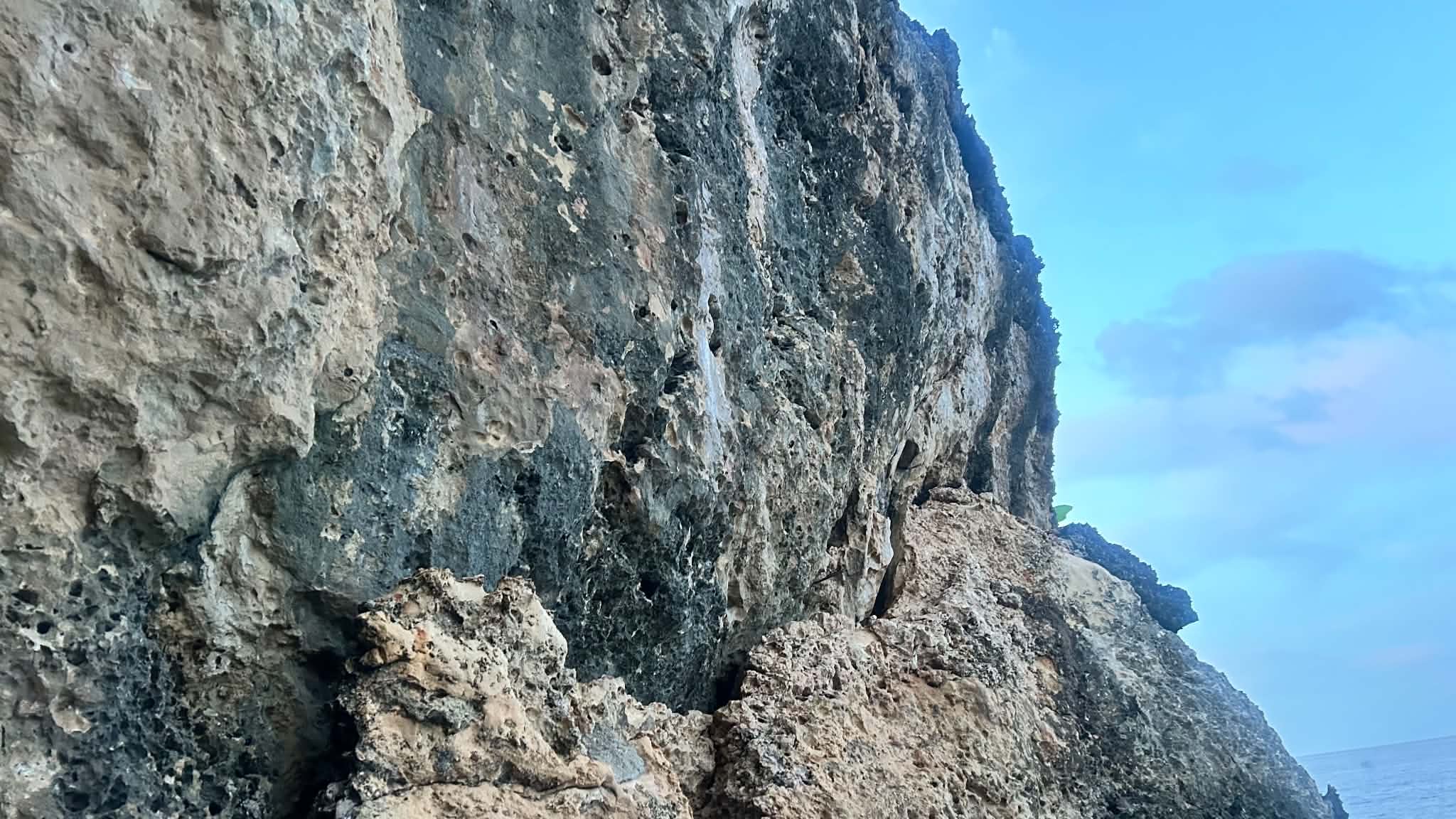 The natural limestone cliff face at Turtle Point rising above the water.